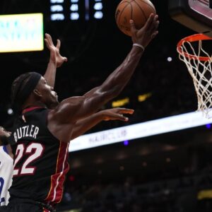 Miami Heat forward Jimmy Butler (22) shoots the ball around Golden State Warriors forward Andrew Wiggins (22) during the second half at FTX Arena.