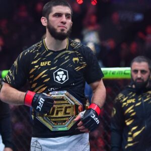 Islam Makhachev (red gloves) reacts after defeating Renato Moicano (not pictured) in a lightweight title fight during UFC 311 at Intuit Dome.