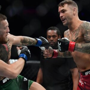 Dustin Poirier moves in for a hit against Conor McGregor during UFC 264 at T-Mobile Arena.