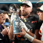 Kansas City Chiefs quarterback Patrick Mahomes passes the the Lombardi Trophy to Travis Kelce after winning the Super Bowl against the Philadelphia Eagles at State Farm Stadium