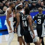 Phoenix Suns forward Kevin Durant (35) and San Antonio Spurs guard Chris Paul (3) exchange words during the first half at Moody Center.