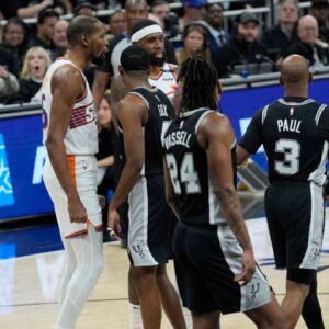 Phoenix Suns forward Kevin Durant (35) and San Antonio Spurs guard Chris Paul (3) exchange words during the first half at Moody Center.
