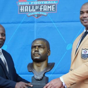 Aug 6, 2022; Canton, OH, USA; Richard Seymour (right) and presenter Titus Duren pose with bust of Seymour during the Pro Football Hall of Fame Class of 2022 Enshrinement at Tom Benson Hall of Fame Stadium.