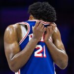 Philadelphia 76ers center Joel Embiid (21) wipes his face during a break in the third quarter against the Boston Celtics at Wells Fargo Center.