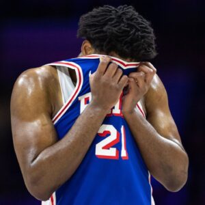 Philadelphia 76ers center Joel Embiid (21) wipes his face during a break in the third quarter against the Boston Celtics at Wells Fargo Center.
