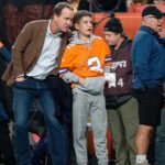 Former Denver Broncos player Peyton Manning with his son Marshall before the game against the Cleveland Browns at Empower Field at Mile High.