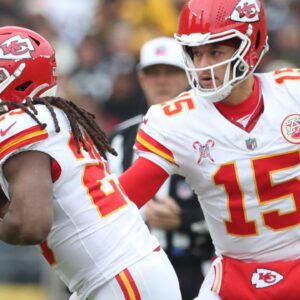 Kansas City Chiefs running back Kareem Hunt (29) takes a hand-off from quarterback Patrick Mahomes (15) against the Pittsburgh Steelers during the first quarter at Acrisure Stadium.