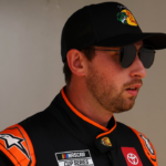 Feb 16, 2025; Daytona Beach, Florida, USA; NASCAR Cup Series driver Chase Briscoe (19) walks to the drivers meeting before the Daytona 500 at Daytona International Speedway. Mandatory Credit: Peter Casey-Imagn Images