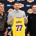 Los Angeles Lakers guard Luka Doncic poses for photos with general manager Rob Pelinka and head coach JJ Redick at UCLA Health Training Center.