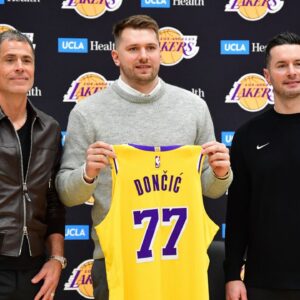 Los Angeles Lakers guard Luka Doncic poses for photos with general manager Rob Pelinka and head coach JJ Redick at UCLA Health Training Center.