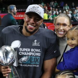 Feb 9, 2025; New Orleans, LA, USA; Philadelphia Eagles running back Saquon Barkley holds the Lombardi Trophy with his family after the championship trophy presentation after the Eagles' game against the Kansas City Chiefs in Super Bowl LIX at Caesars Superdome.