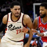 Detroit Pistons forward Tobias Harris (12) dribbles defended by Philadelphia 76ers forward Paul George (8) in the second half at Little Caesars Arena.