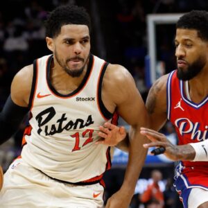 Detroit Pistons forward Tobias Harris (12) dribbles defended by Philadelphia 76ers forward Paul George (8) in the second half at Little Caesars Arena.