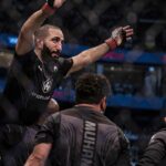 Belal Muhammad (red gloves) defeats Sean Brady (blue gloves) during UFC 280 at Etihad Arena.