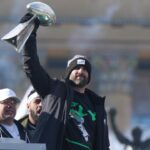 Philadelphia Eagles head coach Nick Sirianni raises the Vince Lombardi Trophy during the Super Bowl LIX championship parade and rally.