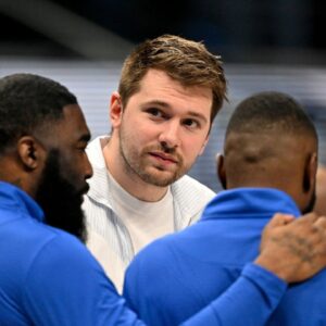 Dallas Mavericks guard Luka Doncic (center) talks with team staff during the second quarter against the Denver Nuggets at the American Airlines Center.