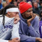 Phoenix Suns guard Damion Lee (10) and Phoenix Suns forward Kevin Durant (35) watch their team play against the Oklahoma City Thunder during the second half of a game at Paycom Center.