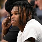 2024 Heisman Trophy winner Travis Hunter Jr. looks during the first half of the game between the Dallas Mavericks and the Minnesota Timberwolves at the American Airlines Center.
