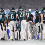 Philadelphia Eagles running back Saquon Barkley (26) and his team huddle up for a play against the Los Angeles Rams in a 2025 NFC divisional round game at Lincoln Financial Field.