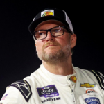 Jul 20, 2024; Hampton, VA, USA; Dale Earnhardt Jr. waits next to his during qualifying for the 16th Annual Hampton Heat at Langley Speedway. Mandatory Credit: Peter Casey-Imagn Images
