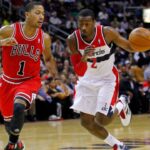Washington Wizards point guard John Wall (2) dribbles the ball as Chicago Bulls point guard Derrick Rose (1) defends in the first half at Verizon Center.
