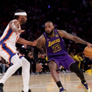Los Angeles Lakers forward LeBron James (23) controls the ball against New York Knicks forward Precious Achiuwa (5) during the third quarter at Madison Square Garden.