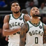 Milwaukee Bucks forward Giannis Antetokounmpo (34) and guard Damian Lillard (0) look on in the second quarter against the Chicago Bulls at Fiserv Forum.