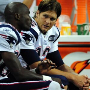 New England Patriots quarterback Tom Brady (right) talks to teammate wide receiver Chad Ochocinco (left) during the second half against the Detroit Lions at Ford Field. Lions won 34 to 10.