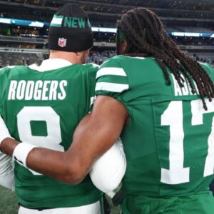 Jan 5, 2025; East Rutherford, New Jersey, USA; New York Jets quarterback Aaron Rodgers (8) and wide receiver Davante Adams (17) walk on the field after the Jets win over the Miami Dolphins at MetLife Stadium.
