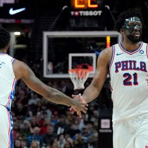Philadelphia 76ers center Joel Embiid (21) and forward Paul George (8) high five during the second half against the Portland Trail Blazers at Moda Center.