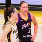 Indiana Fever guard Caitlin Clark (22) and Phoenix Mercury guard Diana Taurasi (3) talk at half court during a free throw on June 30, 2024, at Footprint Center in Phoenix.