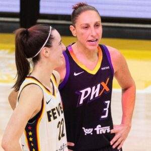 Indiana Fever guard Caitlin Clark (22) and Phoenix Mercury guard Diana Taurasi (3) talk at half court during a free throw on June 30, 2024, at Footprint Center in Phoenix.