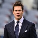 Former quarterback and current NFL announcer Tom Brady looks on before the game between the Chicago Bears and Green Bay Packers at Soldier Field.