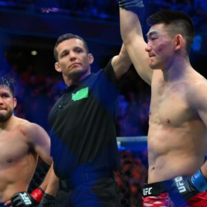 ; Song Yadong (blue gloves) celebrates after defeating Henry Cejudo (red gloves) in the bantamweight bout during UFC Fight Night at Climate Pledge Arena.