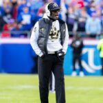 Colorado head coach Deion Sanders paces the field during the 2nd quarter between the Kansas Jayhawks and the Colorado Buffaloes at GEHA Field at Arrowhead Stadium.