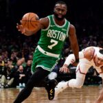 Boston Celtics guard Jaylen Brown (7) gains possession of the ball ahead of New York Knicks guard Josh Hart (3) during the second half at TD Garden.