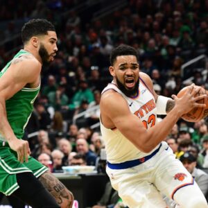 New York Knicks center Karl-Anthony Towns (32) controls the ball while Boston Celtics forward Jayson Tatum (0) defends during the first half at TD Garden.