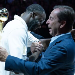 Golden State Warriors forward Draymond Green (23) hugs owner Joe Lacob (right) after receiving his championship ring before the game against the Los Angeles Lakers at Chase Center.