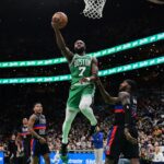 Boston Celtics guard Jaylen Brown (7) shoots a layup against the Detroit Pistons during the second half at TD Garden.