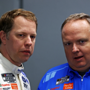 NASCAR Cup Series driver Brad Keselowski (6) talks to his crew chief Jeremy Bullins during practice for the Daytona 500 at Daytona International Speedway.