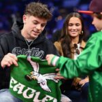 Philadelphia Eagles Cooper DeJean interacts with fans during the game between the Philadelphia 76ers and the Toronto Raptors at Wells Fargo Center.