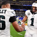 Nov 24, 2024; Inglewood, California, USA; Philadelphia Eagles quarterback Jalen Hurts (1) celebrates with running back Saquon Barkley (26) after the Eagles defeat the Los Angeles Rams during the first half at SoFi Stadium.