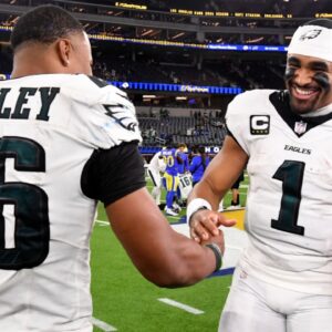 Nov 24, 2024; Inglewood, California, USA; Philadelphia Eagles quarterback Jalen Hurts (1) celebrates with running back Saquon Barkley (26) after the Eagles defeat the Los Angeles Rams during the first half at SoFi Stadium.