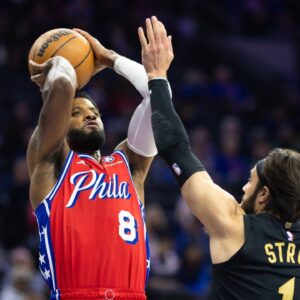 Philadelphia 76ers forward Paul George (8) shoots against Cleveland Cavaliers guard Max Strus (1) during the first quarter at Wells Fargo Center