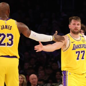 Los Angeles Lakers forward LeBron James (23) and guard Luka Doncic (77) celebrate after a play during the third quarter against the Charlotte Hornets at Crypto.com Arena