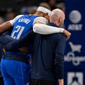 Dallas Mavericks center Daniel Gafford (21) is helped off the court during the second quarter against the Sacramento Kings at the American Airlines Center.