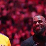 Los Angeles Lakers forward LeBron James, right, and forward Anthony Davis during pregame ceremonies before a game against the Miami Heat at Kaseya Center