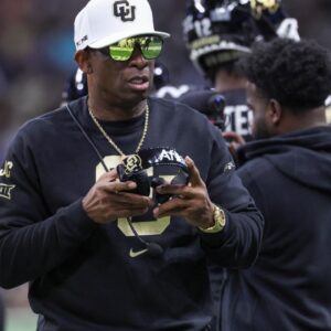 Colorado Buffaloes head coach Deion Sanders walks on the field between plays during the first quarter against the Brigham Young Cougars at Alamodome.