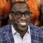 Shannon Sharpe poses with members of the Savannah State Marching Band after a broadcast of \"First Take\" at SSU Monday