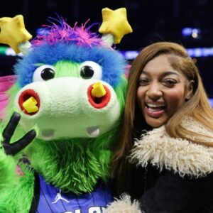 Dec 23, 2024; Orlando, Florida, USA; Chicago Sky forward Angel Reese hugs Orlando Magic Stuff during an NBA game against the Boston Celtics at Kia Center.